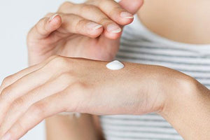 Face cream on back of hand