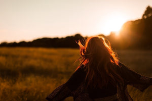 Lady in a field with sunset