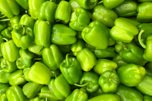 a pile of bright green peppers